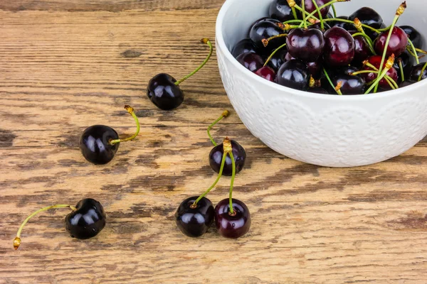 Red cherries in a white ceramic bowl. — Stock Photo, Image