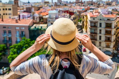 Hasır şapkalı genç bir kız yukarıdan Valencia 'ya bakıyor.