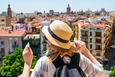 Hasır şapkalı genç bir kız yukarıdan Valencia 'ya bakıyor.