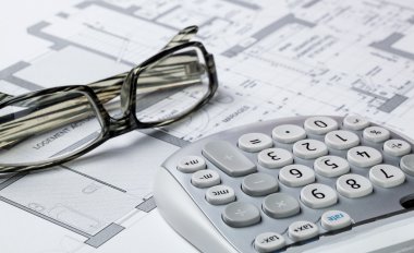 property design and cost concept with architect eyeglasses and calculator on computer rendering clipart