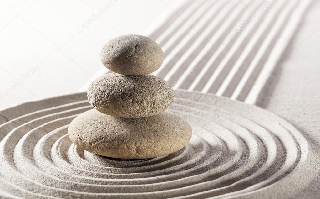 balanced pebbles in sand for meditation and contemplation