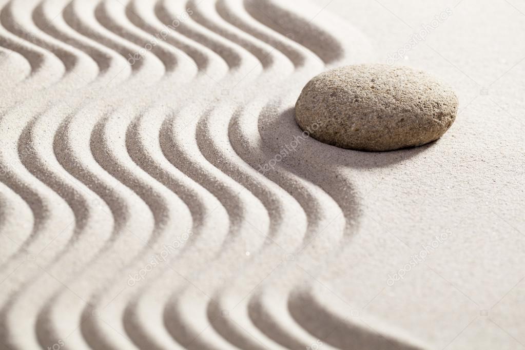 sinuous path in sand for philosophy of life with stone on the border waves