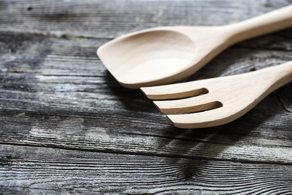 Wooden spoon and fork on genuine old wood table for cuisine — Stock Photo, Image