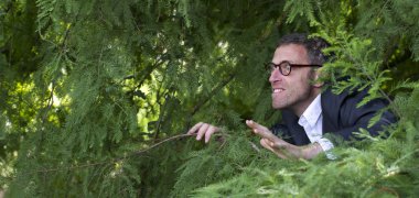 male adolescence concept with red hooded sweater and fun hand gesture