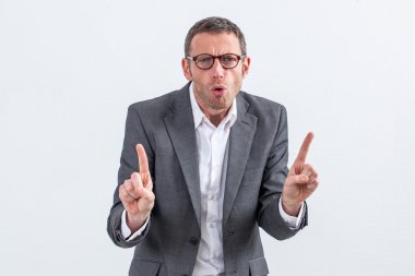 unhappy entrepreneur with eyeglasses warning or threatening someone with indexes raised