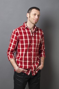 excited 40s man with checked shirt pointing finger to show something on side