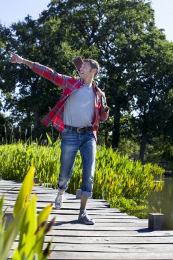 su kenarında yürüyüş holding gitar heyecanlı 40'lı adam