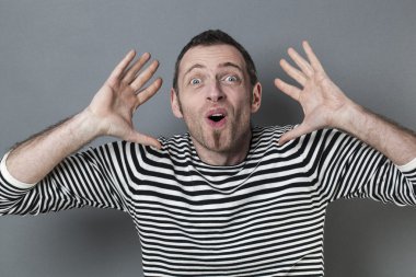 excited 40s man with checked shirt pointing finger to show something on side