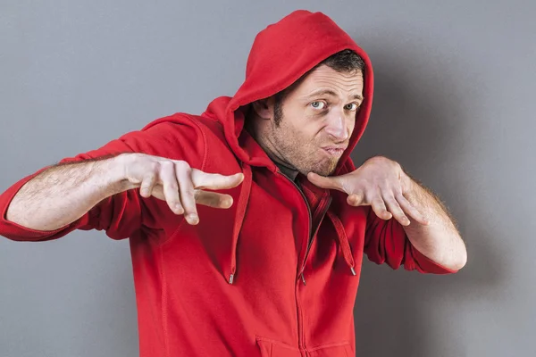 Boxe d'âge moyen portant un pull à capuche rouge jouant rapper avec geste amusant de la main — Photo