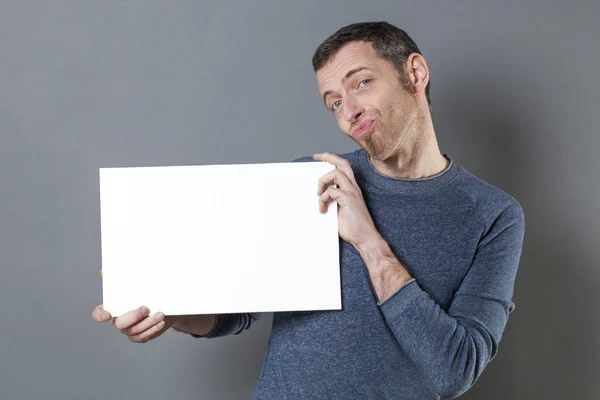 Hombre de aspecto divertido cuestionando lo que muestra en su banner de espacio de copia — Foto de Stock