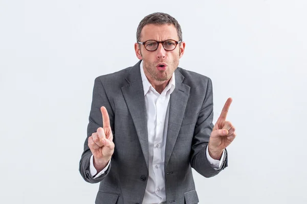 Unhappy entrepreneur with eyeglasses warning or threatening someone with indexes raised — Stockfoto