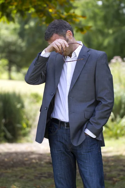 excited 40s man with checked shirt pointing finger to show something on side