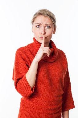 unhappy young blond keeping her lips tight for quiet discretion, taboo or silence
