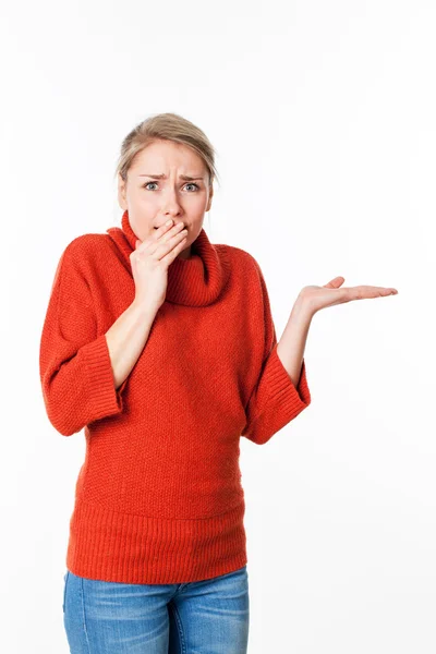 Scared young woman expressing fear and apprehension in holding something secret in an empty hand — Stock Photo, Image