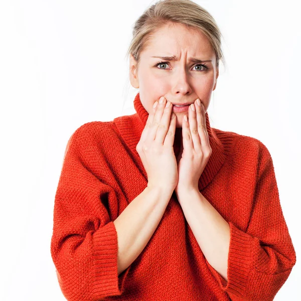 Scared young blond woman hiding her face with her hands for anxiety, worry and regret — Stock Photo, Image