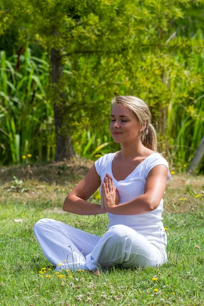All'aperto meditazione zen 20s ragazza bionda rivitalizzando se stessa, dintorni del parco — Foto Stock
