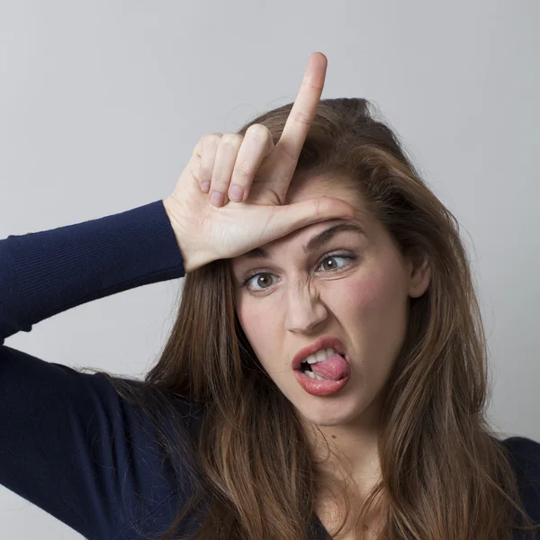 Joking 20's woman insulting herself or someone with L loser hand gesture — Stock Photo, Image