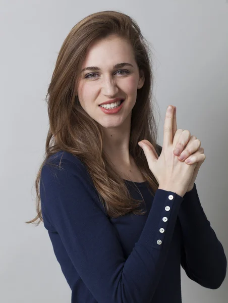 Bela jovem com dedo arma mão para metáfora sexy — Fotografia de Stock
