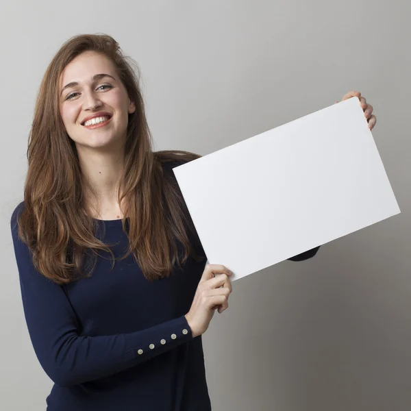 Emocionada mujer de 20 años haciendo un anuncio en la visualización de un inserto blanco delante de ella — Foto de Stock