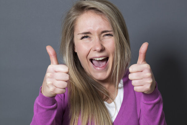ecstatic 20s woman with double thumbs up