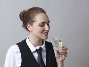 focused 20s girl tasting bubbly wine at party to celebrate success at becoming sommelier
