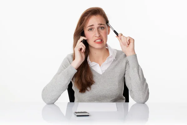 Worried 20s business woman thinking on phone in white office — 스톡 사진
