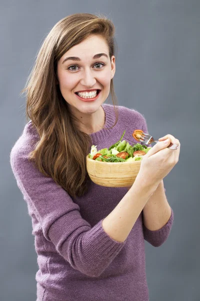 thrilled 20s girl ready to eat appetizing veggie food for pleasure of having fresh diet