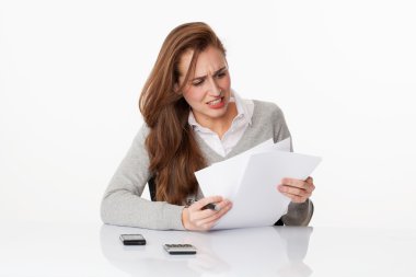 worried 20s woman classifying administrative files and paperwork in office