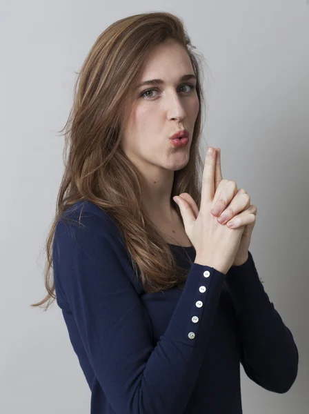 Joven mujer soplando en dedo pistola de mano para sexy metáfora —  Fotos de Stock