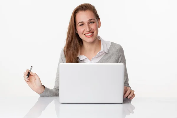 Thrilled 20s girl working at her desk with satisfaction Stock Image