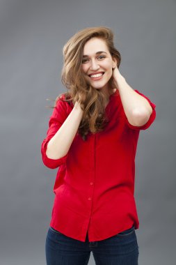 smiling young woman posing with softly folded arms for comfort