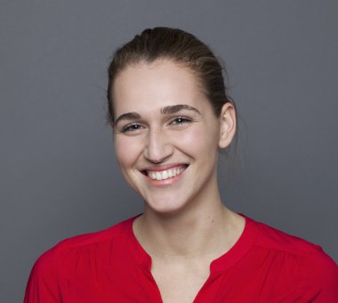 closeup of a radiant young woman smiling expressing natural happiness