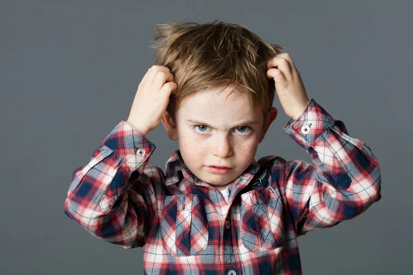 Unhappy kid scratching his hair for head lice or allergies — Stock Photo, Image