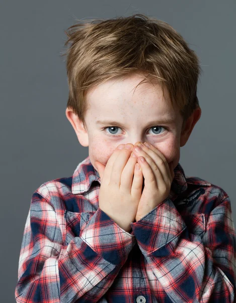 Mischievous beautiful child with excited blue eyes for shyness — Stock Photo, Image