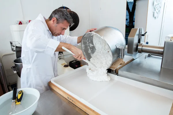 Pouring of Italian white dough with roasted almonds for nougat — Stock Photo, Image