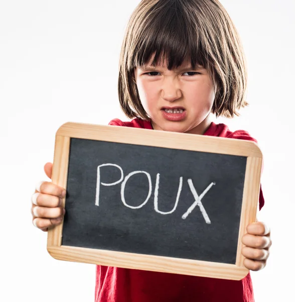 Furious young boy repulsing head lice with school slate — Stock Photo, Image