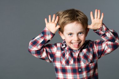 young child enjoying making a funny face, sticking out tongue