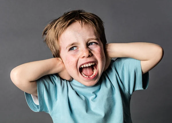 Screaming young boy suffering from domestic pain covering his ears — Stock Photo, Image