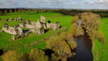 Hava manzarası, canlı yeşil alanlar ve ağaçların arasına yerleştirilmiş entrika dolu taş kalıntılarını ortaya çıkarıyor. Yakınlarda yumuşak bir nehir akıyor ve İrlanda manzarasına huzur katıyor..