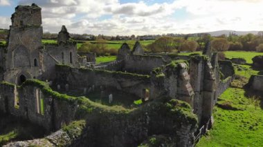 Parlak bir gökyüzünün altındaki yemyeşil tarlalarda gizlenmiş mistik bir şatonun güzelliğini keşfedin. Doğa, geçmişin hikayelerini anlatarak antik taşları kucaklıyor..