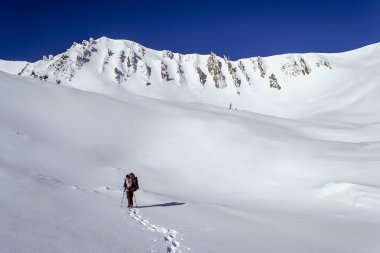 Winter trekking in high snowy mountains