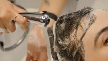 Professional hair washing service in a modern barbershop.