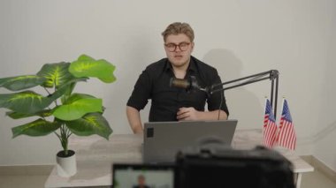 Erkek içerik yaratıcısı modern stüdyoda canlı yayına hazırlanıyor..