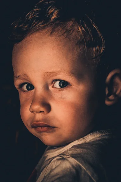 A child on a black background — Stock Photo, Image