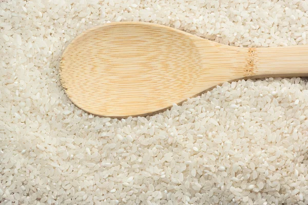 White rice on a wooden background — Stock Photo, Image