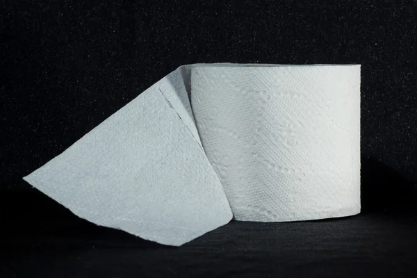 Toilet paper on a black background — Stock Photo, Image