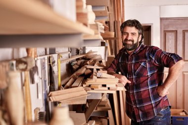 carpenter standing confidently in workshop clipart