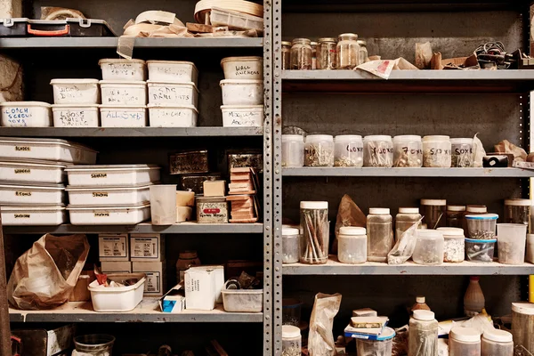 Shelves in workshop with variety of different containers — Stock Photo, Image