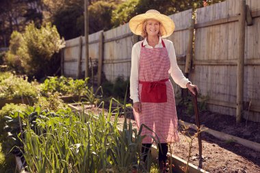 woman standing in urban food garden