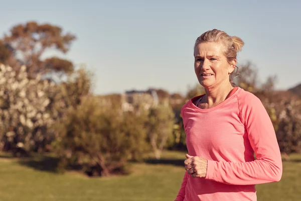 Atletisk Senior Kvinna jogging utomhus — Stockfoto